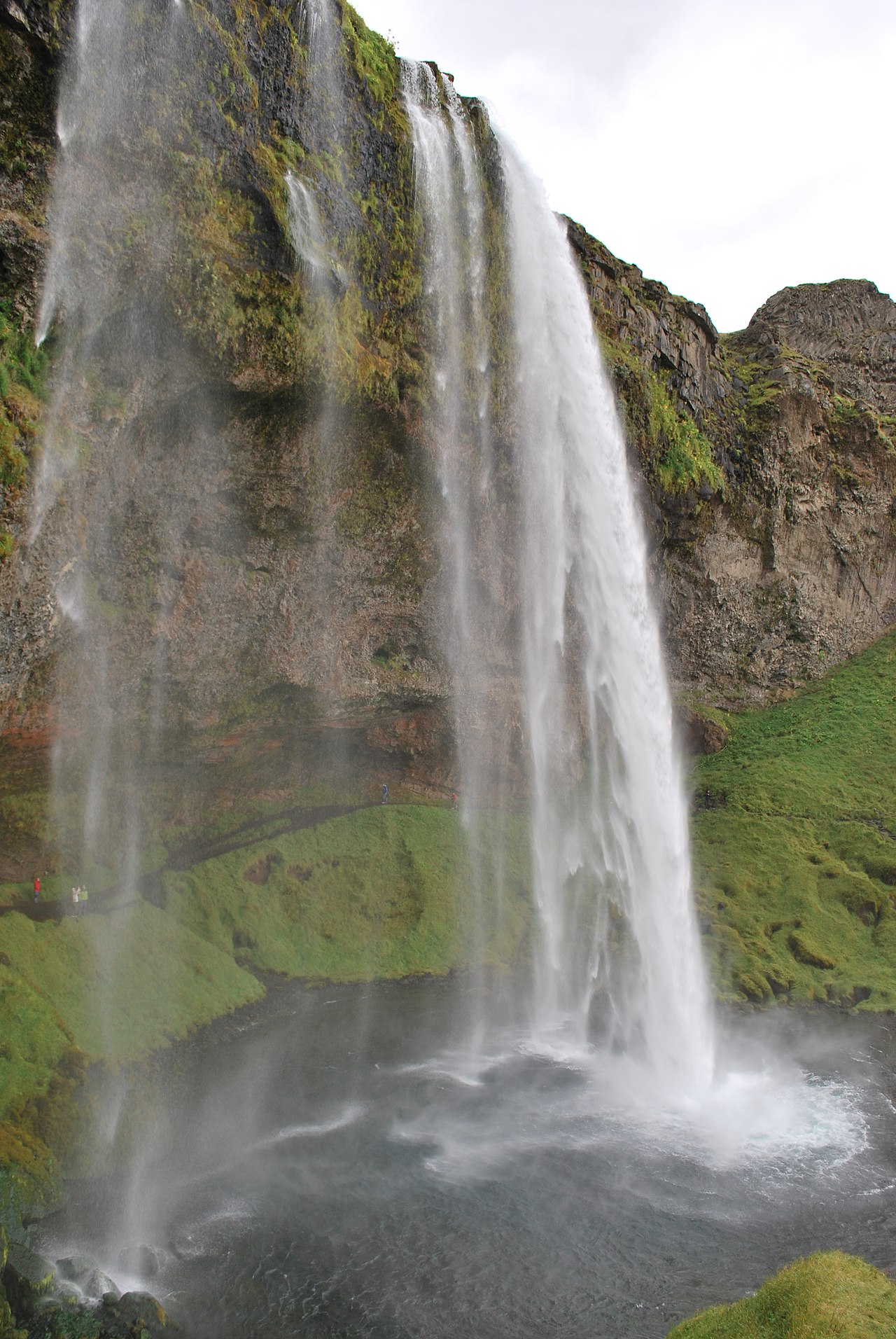 Waterfall and green cliffs on Iceland's South Coast